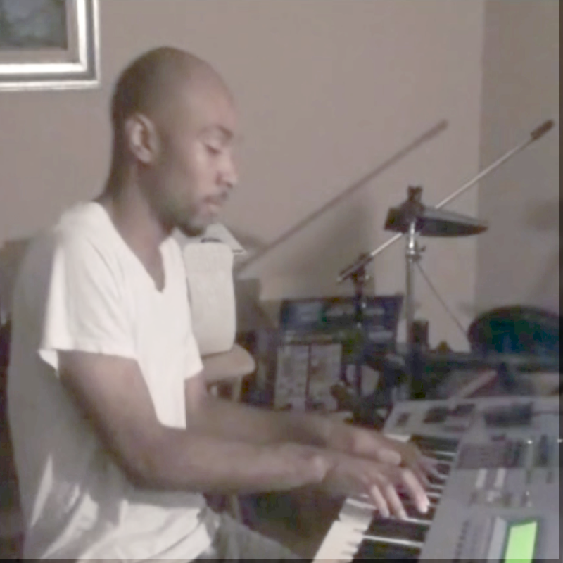 Archival photograph of the creator working at a keyboard